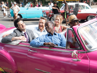 Ben Schwartz, back left, as Clyde Oberholt; Josh Lawson as Doug Guggenheim; Kristen Bell as Jeannie Van Der Hooven and Don Cheadle as Marty Kaan catching a ride in Cuba in the series finale.